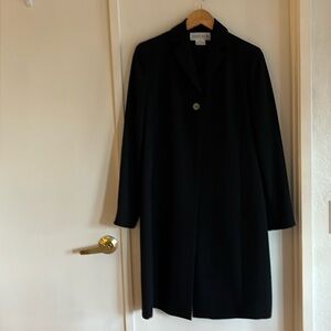 Black Jacket with one button and slacks have zipper with clasp and hidden button
